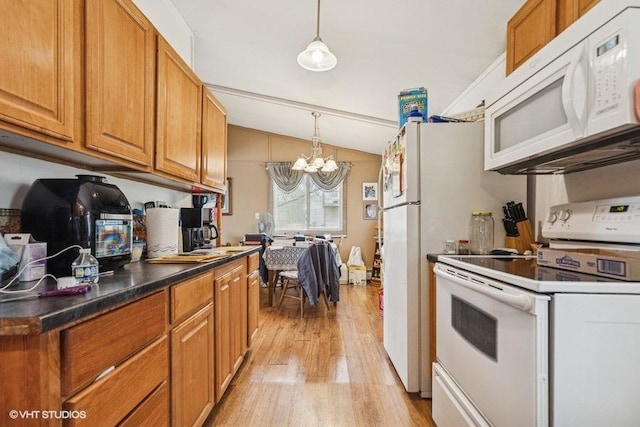 904 Washington St, Saint Croix Falls, WI 54024 - kitchen featuring white appliances, a notable chandelier, brown cabinetry, and light wood finished floors