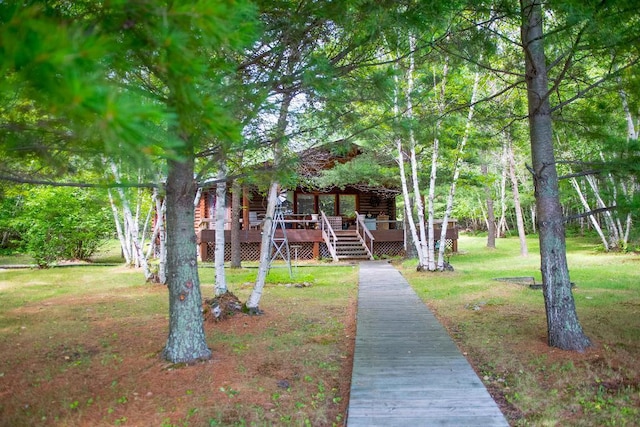 view of front of home featuring a front lawn and a wooden deck