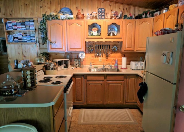 kitchen with wood walls, a sink, wooden ceiling, lofted ceiling, and white appliances