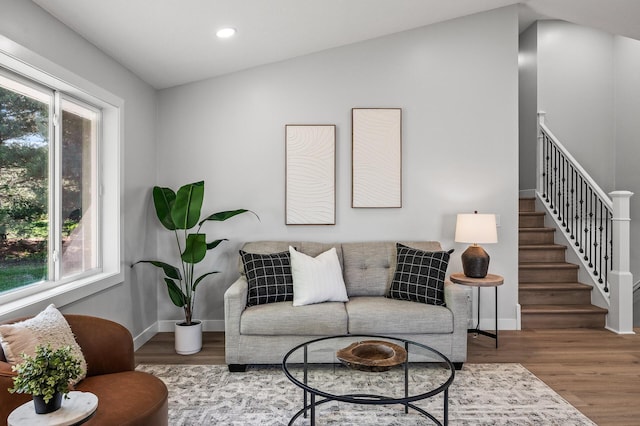 living room featuring healthy amount of natural light, wood finished floors, recessed lighting, and baseboards