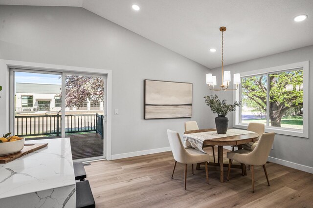 dining room with recessed lighting, a chandelier, light wood-style flooring, baseboards, and high vaulted ceiling
