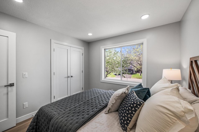 bedroom featuring wood finished floors, baseboards, and recessed lighting
