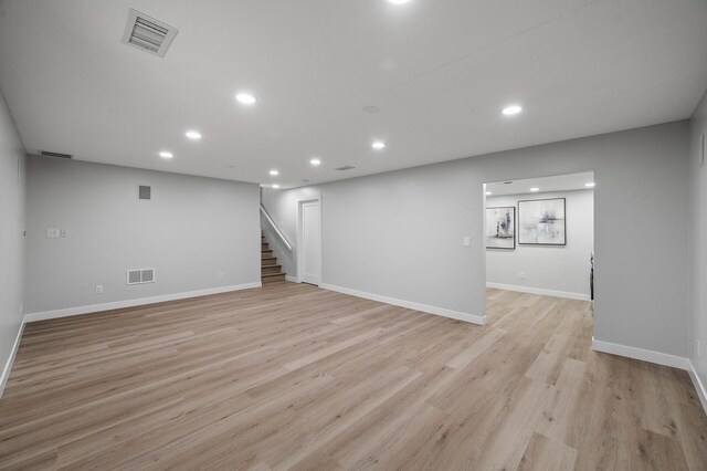finished basement with recessed lighting, stairs, baseboards, and light wood-style floors
