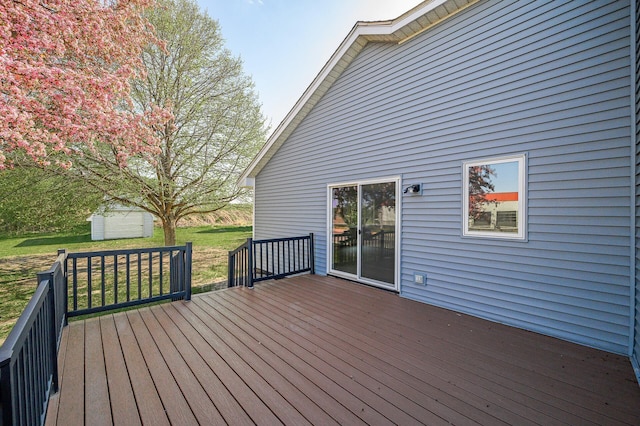 deck featuring a yard and an outdoor structure