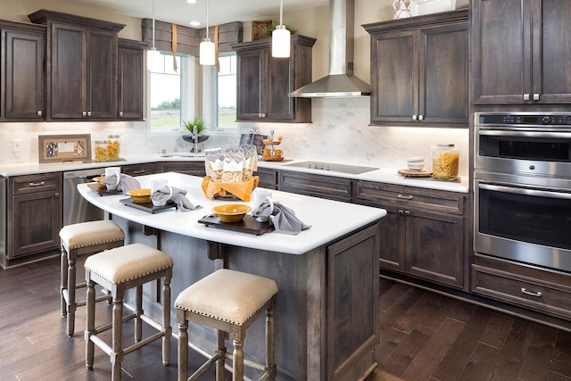 14897 144th Ave N, Dayton, MN 55327 - kitchen featuring stainless steel double oven, wall chimney range hood, dark wood finished floors, a kitchen bar, and dark brown cabinetry