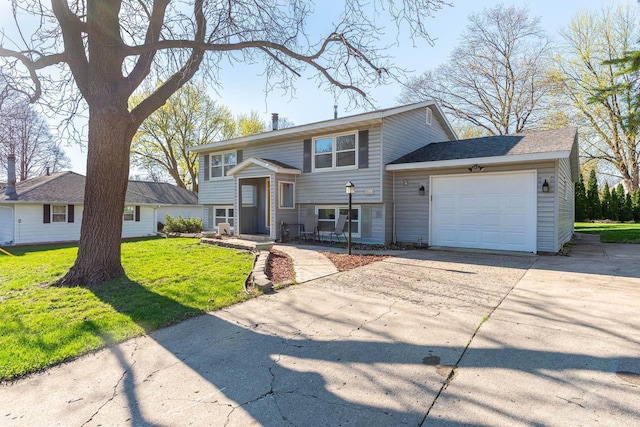 bi-level home with driveway, a garage, and a front yard