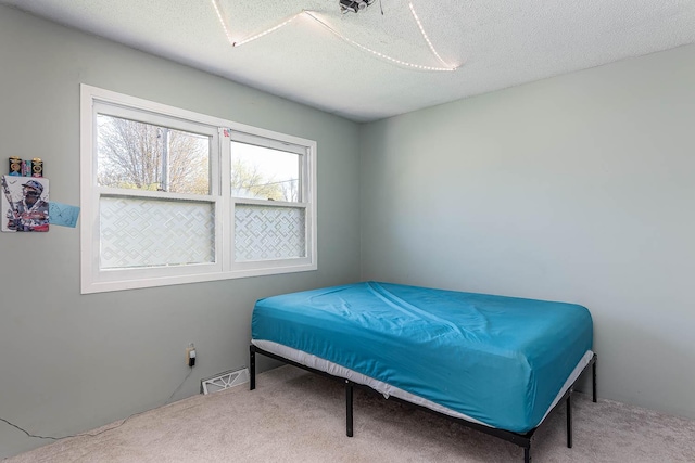carpeted bedroom with a textured ceiling