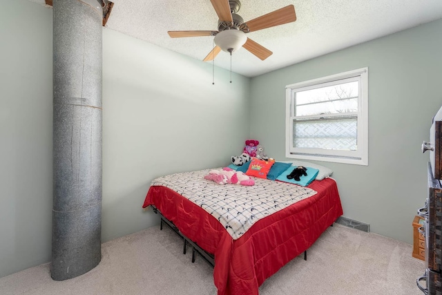bedroom with carpet, ceiling fan, and a textured ceiling