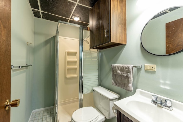 bathroom with a stall shower, toilet, and vanity
