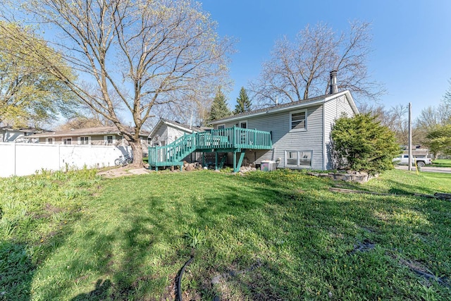 rear view of property featuring a deck and stairs