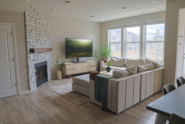 5275 94th Ln N, Brooklyn Park, MN 55443 - living area featuring recessed lighting, a stone fireplace, and wood finished floors