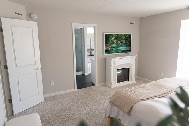 5275 94th Ln N, Brooklyn Park, MN 55443 - bedroom featuring carpet flooring, a glass covered fireplace, baseboards, and visible vents