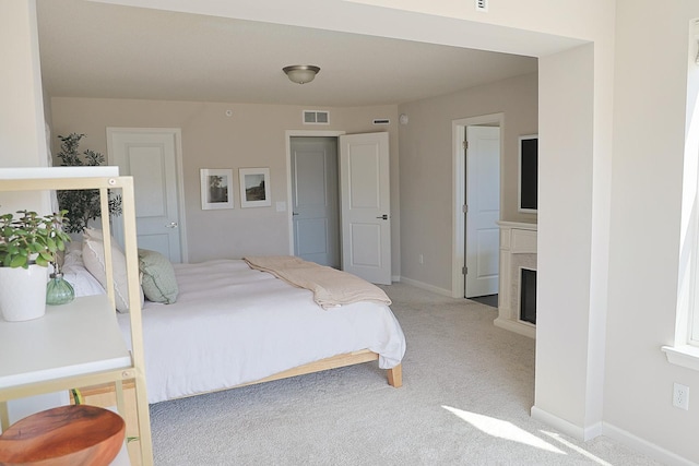 5275 94th Ln N, Brooklyn Park, MN 55443 - carpeted bedroom featuring visible vents, a fireplace, and baseboards