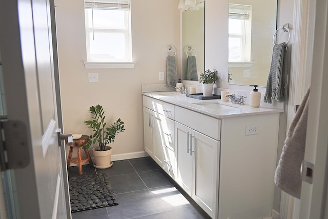 5275 94th Ln N, Brooklyn Park, MN 55443 - bathroom with double vanity, tile patterned flooring, a healthy amount of sunlight, and a sink