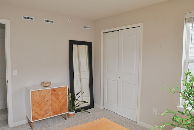 5275 94th Ln N, Brooklyn Park, MN 55443 - bedroom featuring baseboards, a closet, visible vents, and light colored carpet