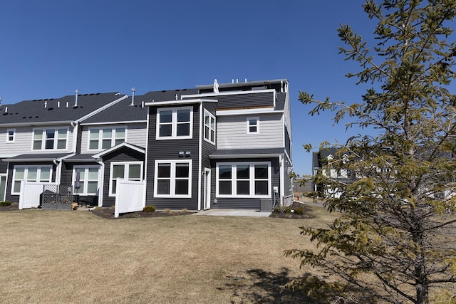 5275 94th Ln N, Brooklyn Park, MN 55443 - back of house with a yard, fence, and a patio