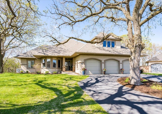 2222 White Oak Ct, Hudson, WI 54016 - view of front of home featuring stucco siding, asphalt driveway, a front lawn, and an attached garage