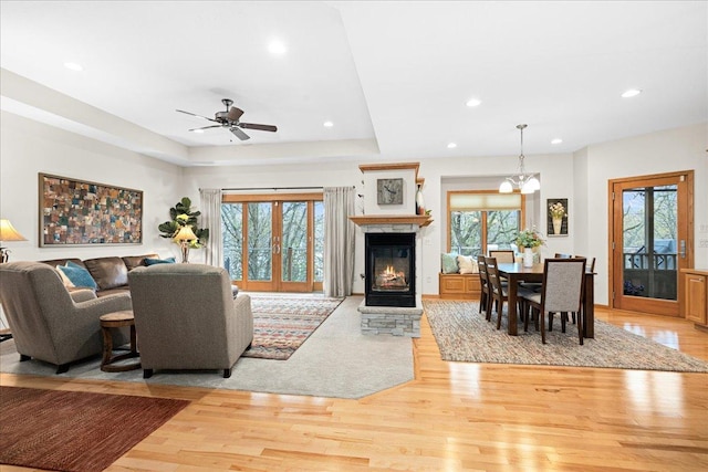 2222 White Oak Ct, Hudson, WI 54016 - living area featuring plenty of natural light, light wood-style floors, a glass covered fireplace, recessed lighting, and ceiling fan
