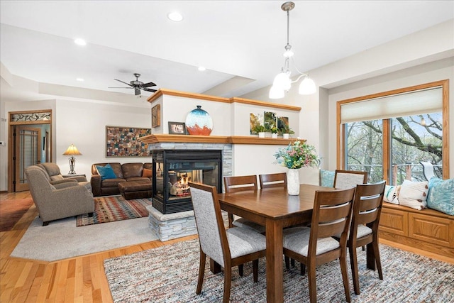 2222 White Oak Ct, Hudson, WI 54016 - dining space with a stone fireplace, ceiling fan, light wood-style flooring, and recessed lighting