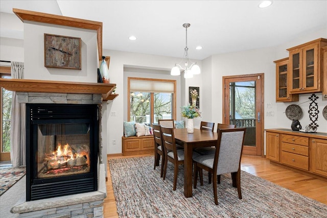 2222 White Oak Ct, Hudson, WI 54016 - dining area featuring light wood-style floors, plenty of natural light, a fireplace, a chandelier, and recessed lighting