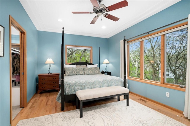 2222 White Oak Ct, Hudson, WI 54016 - bedroom featuring wood finished floors, a ceiling fan, and crown molding