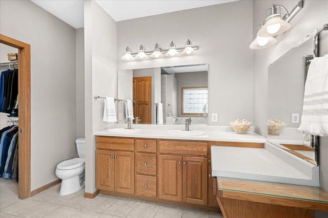 2222 White Oak Ct, Hudson, WI 54016 - full bathroom featuring double vanity, tile patterned flooring, and a walk in closet