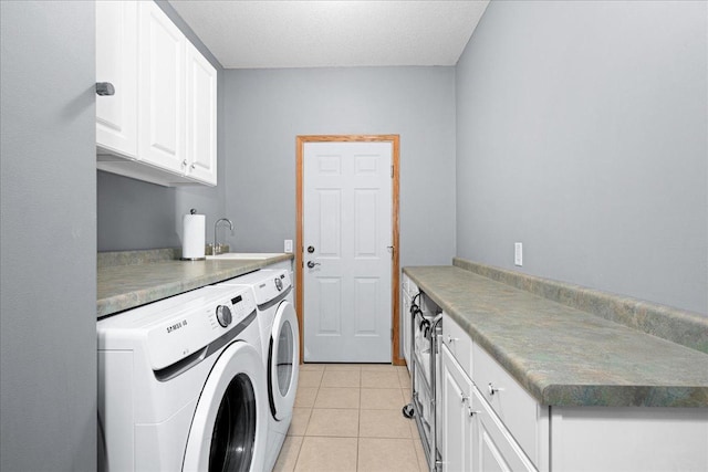 2222 White Oak Ct, Hudson, WI 54016 - washroom with washer and clothes dryer, light tile patterned floors, and cabinet space