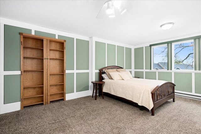 2222 White Oak Ct, Hudson, WI 54016 - carpeted bedroom with a baseboard heating unit and ceiling fan