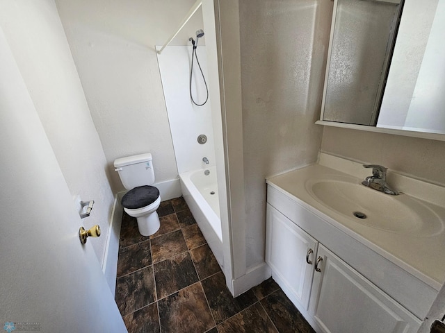 full bathroom featuring toilet, stone finish flooring, shower / washtub combination, baseboards, and vanity