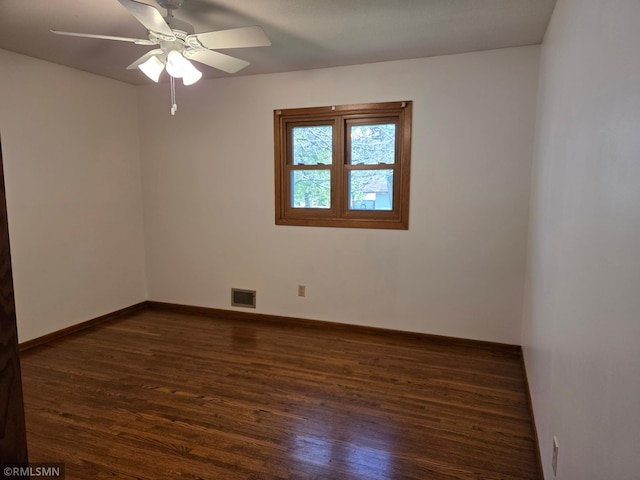 empty room featuring baseboards, a ceiling fan, dark wood-style floors, and visible vents