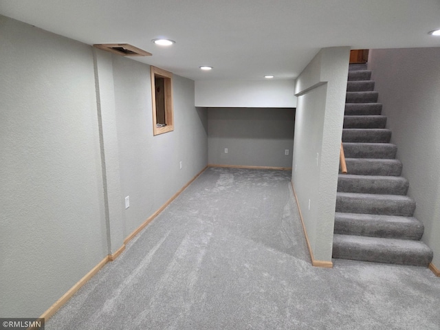 finished basement with recessed lighting, baseboards, carpet, and stairs