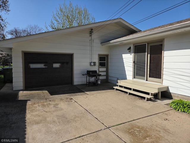 exterior space featuring concrete driveway and a garage