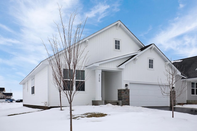 view of front facade with a garage and board and batten siding
