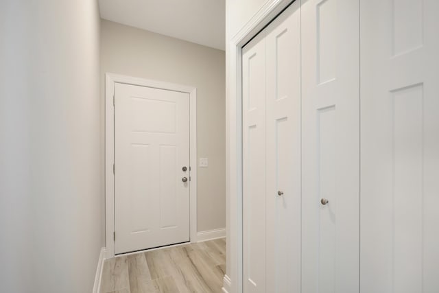 entryway with baseboards and light wood-style floors