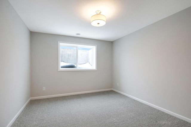 empty room featuring baseboards and carpet