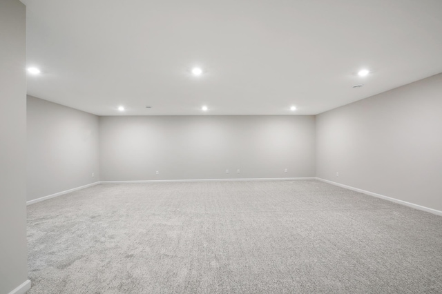 empty room with recessed lighting, baseboards, and light colored carpet