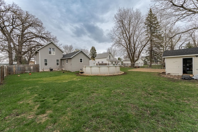 15 2nd St SE, Dodge Center, MN 55927 - view of yard with a fenced backyard, an outdoor structure, and a fenced in pool