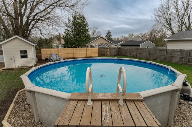 15 2nd St SE, Dodge Center, MN 55927 - view of swimming pool with an outdoor structure, a fenced backyard, a fenced in pool, and a shed