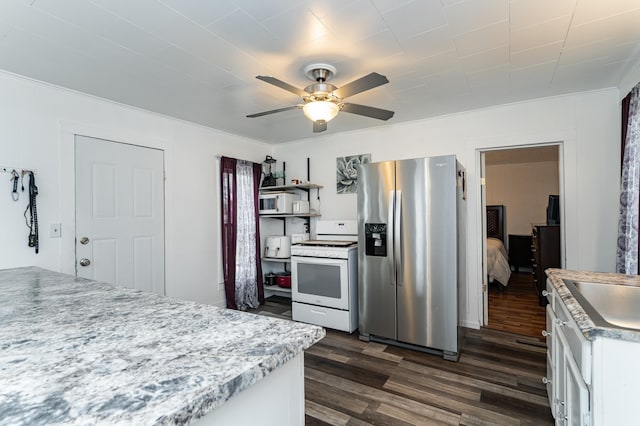15 2nd St SE, Dodge Center, MN 55927 - kitchen featuring stainless steel refrigerator with ice dispenser, dark wood finished floors, white cabinetry, ceiling fan, and gas range gas stove