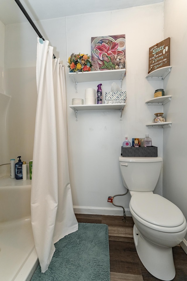 15 2nd St SE, Dodge Center, MN 55927 - full bathroom featuring toilet, baseboards, a shower with curtain, and wood finished floors