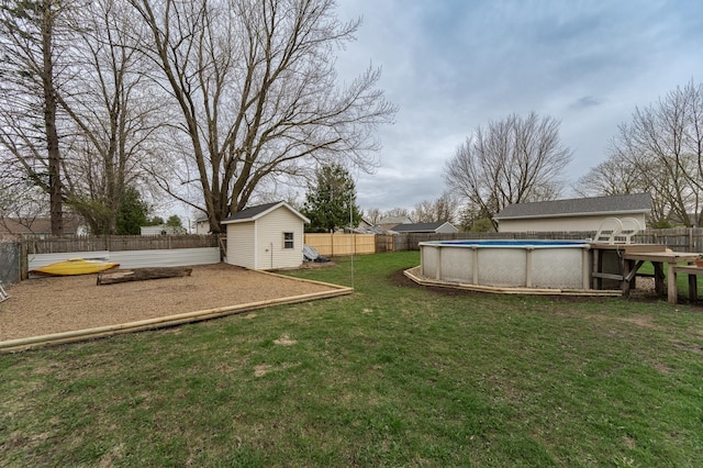 15 2nd St SE, Dodge Center, MN 55927 - view of yard featuring an outdoor structure, a fenced in pool, a fenced backyard, and a storage unit