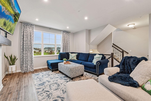 living room featuring wood finished floors, baseboards, and recessed lighting