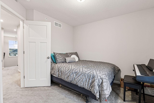 carpeted bedroom featuring a textured ceiling