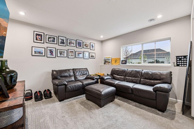 living room with carpet floors, recessed lighting, and baseboards