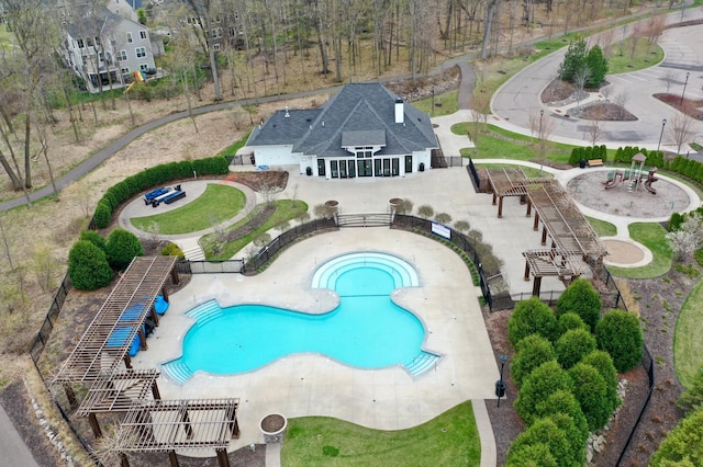 community pool featuring fence, stairs, and a patio area