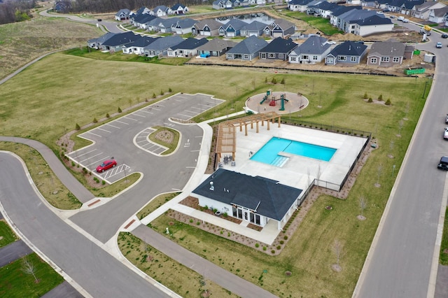 aerial perspective of suburban area featuring a pool