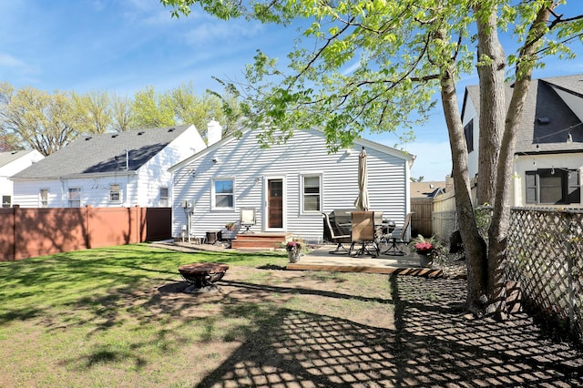 2102 Pinehurst Ave, Saint Paul, MN 55116 - back of property with an outdoor fire pit, a patio, and a chimney