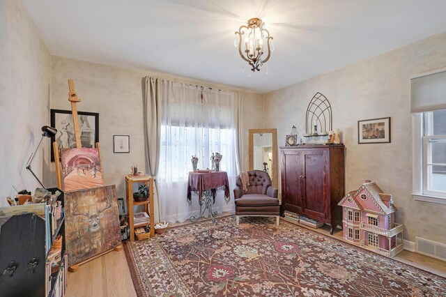 2102 Pinehurst Ave, Saint Paul, MN 55116 - sitting room featuring wood finished floors and a chandelier