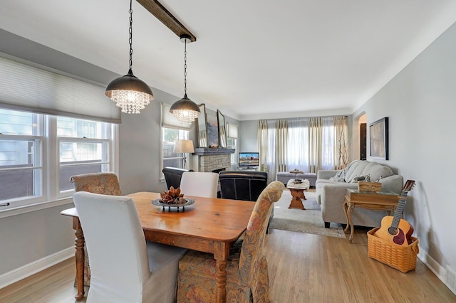 2102 Pinehurst Ave, Saint Paul, MN 55116 - dining area featuring light wood-style floors, a fireplace, and baseboards