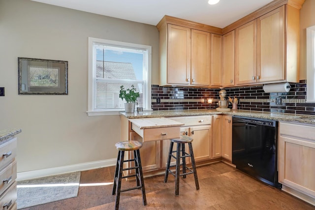 2102 Pinehurst Ave, Saint Paul, MN 55116 - kitchen featuring black dishwasher, decorative backsplash, light brown cabinetry, and light stone counters